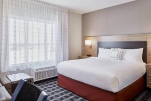 a hotel room with a bed and a window at TownePlace Suites by Marriott Medicine Hat in Medicine Hat +17 photos