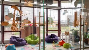 a room with windows with colorful bags on the floor at Wellton Riga Hotel & SPA in Riga