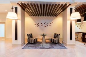 a lobby with chairs and a table and a piano at Atlanta Marriott Northeast/Emory Area in Atlanta +61 photos