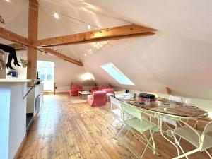 a kitchen and a living room with a table and chairs at Duplex 70m² 8 pers. à Briançon, proche télécabine, 2 chambres, coin nuit, parking privé - FR-1-330C-1 in Briançon