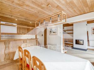 a dining room with a white table and wooden ceilings at Appartement duplex lumineux, 4 pièces, 6 pers, Méribel centre, pistes et commerces à proximité - FR-1-411-736 in Les Allues