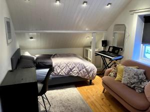 a bedroom with a bed and a desk and a piano at Lovely house in Oslo in Oslo