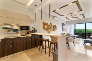 a kitchen with a bar and a dining room at One block from beach in Hotel Zone Free Beach Club in Tulum