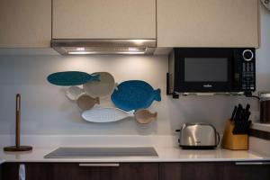 a kitchen with a wall with fish decorations on it at One block from beach in Hotel Zone Free Beach Club in Tulum