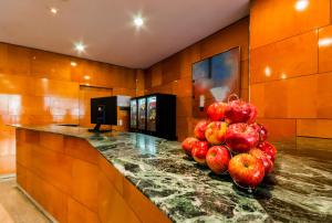 a kitchen area with a counter and a television at Hotel Villacarlos in Valencia