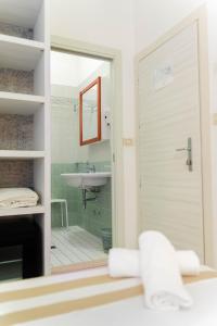 a bathroom with a shower and a sink and a mirror at Strand Hotel in Gabicce Mare +83 photos
