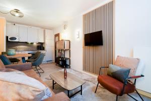 TV a/nebo společenská místnost v ubytování Das Solaris 1 Beach Apartment mit Balkon, hundefreundlich und modern