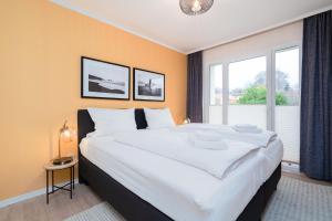 Ένα ή περισσότερα κρεβάτια σε δωμάτιο στο Das Solaris 7 Beach Apartment mit Balkon, Gemeinschaftssauna und Grillplatz