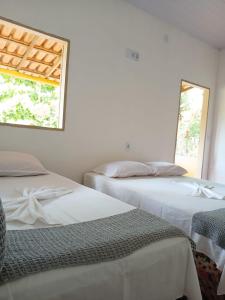 Ένα ή περισσότερα κρεβάτια σε δωμάτιο στο Chalé Ilha Verde-Cumuruxatiba