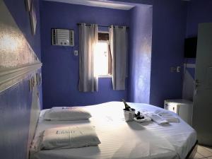 En eller flere senge i et værelse på Hotel Lunar