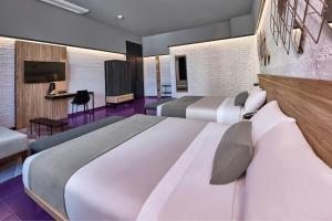 a hotel room with two beds and a flat screen tv at City Centro by Marriott Ciudad de Mexico in Mexico City