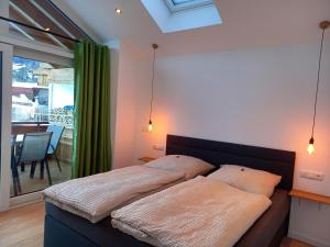 a bedroom with a bed with two pillows on it at Bergzauber Ofterschwang in Ofterschwang +51 photos