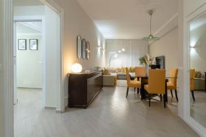 a dining room and living room with a table and chairs at Anastasia Comfort at the Vatican with Balcony in Rome