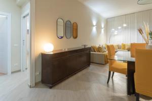 a living room with a table and a couch at Anastasia Comfort at the Vatican with Balcony in Rome
