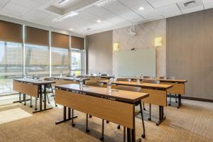 a classroom with desks and a whiteboard in a room at SpringHill Suites Charlotte Southwest in Charlotte +16 photos