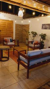 a living room with several benches and a table at VIVEMAR PUNTA HERMOSA - Beach House Lima - Perú in Punta Hermosa +30 photos