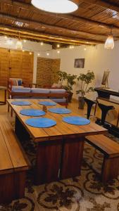 a large wooden table in a room with a piano at VIVEMAR PUNTA HERMOSA - Beach House Lima - Perú in Punta Hermosa
