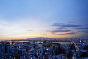 a view of a city at sunset at The Westin Osaka in Osaka