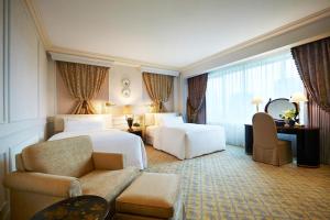 a hotel room with a bed and a couch at The Westin Osaka in Osaka