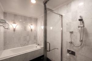 a bathroom with a shower and a tub and a sink at The Westin Osaka in Osaka