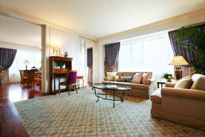 a living room with a couch and a table at The Westin Osaka in Osaka