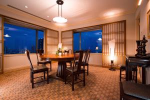 a dining room with a table and chairs and windows at The Westin Osaka in Osaka
