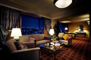 a living room with a couch and chairs and a table at The Westin Osaka in Osaka