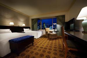a hotel room with a bed and a large window at The Westin Osaka in Osaka