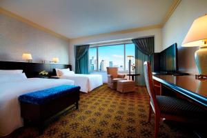 a hotel room with two beds and a large window at The Westin Osaka in Osaka