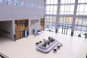 a large lobby with a couch in the middle of a building at Arena Hotel Neftchala in Neftçala