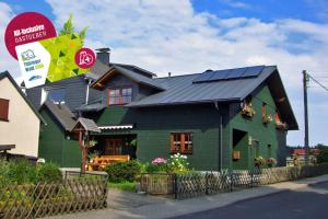 a green house with solar panels on top of it at Ferienwohnung Katrin Spindler in Ilmenau