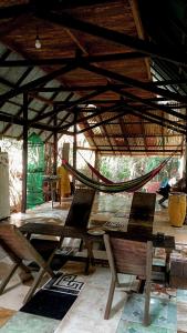 a wooden table with a hammock in a building at Viverde selva Redario natural in Alter do Chao