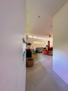 a living room with a white wall and a living room at Ocean View Villa 2min to beach - Casa Cantini in Montezuma +29 photos