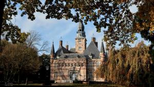 an old castle with a tower on top of it at Hotel Umberto in Wijchen