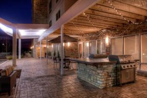 an outdoor bar with a grill on a patio at TownePlace Suites by Marriott St. Louis Chesterfield in Chesterfield