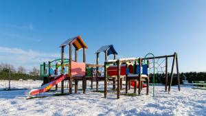 a group of playground equipment in the snow at VacationClub - Baltin Apartament 21 in Mielenko