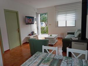 a living room with a couch and a table at Vila Montecelos in Antas de Ulla
