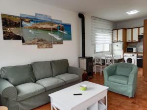 a living room with a couch and a table at Vila Montecelos in Antas de Ulla