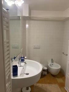 a bathroom with a sink and a toilet at Labanca's l'arco del duomo in Matera +8 photos