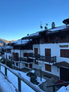 a building with snow on the roofs and windows at Residence Dolomiti in Folgarida