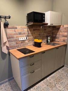 a kitchen with a counter top with a microwave at Gomén in Eger
