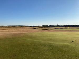a view of a golf course with a green at The Bunker, Golf Cottage in Prestwick