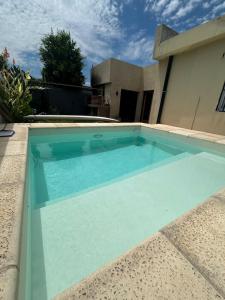 a swimming pool in front of a house at The amphitheater house in Villa María