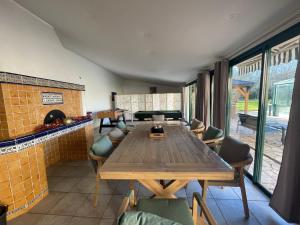a dining room with a wooden table and chairs at Demeure de Charme de la Gravière in Mably
