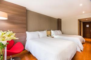 Postel nebo postele na pokoji v ubytování Cosmos 100 Hotel & Centro de Convenciones - Hoteles Cosmos