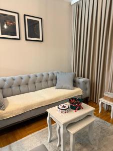 a living room with a couch and a table at Urban Apartman-privatan parking- in Kraljevo
