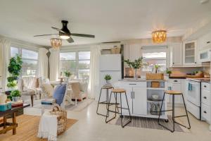 プンタ・ゴーダにあるDock and Lanai Waterfront Punta Gorda Cottageの白いキャビネット付きのキッチン、リビングルーム
