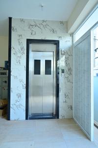 a hallway with a glass door in a building at Vaarahi Guest Inn in Nellore