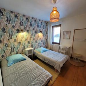 Ένα ή περισσότερα κρεβάτια σε δωμάτιο στο La Maison de Marie « Le Rocher »