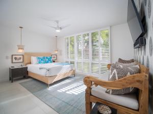 a bedroom with a bed and a window at Exclusive Oceanfront Access at Alaeloa #3 in Kahana